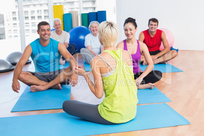 Instructor talking with class in fitness club