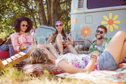 Happy hipsters relaxing on the campsite