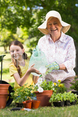 Happy grandmother with her granddaughter gardening