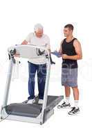 Senior man on treadmill with trainer