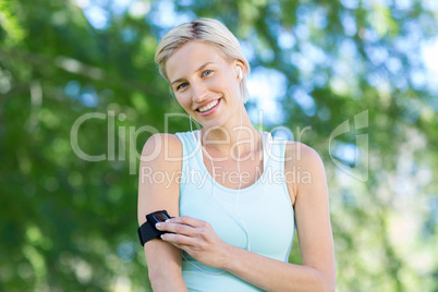 Pretty blonde jogging with music