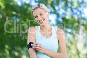 Pretty blonde jogging with music