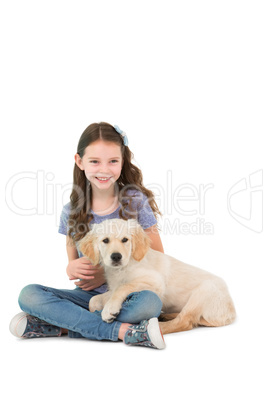 Happy little girl sitting with dog on her legs