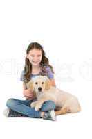 Happy little girl sitting with dog on her legs