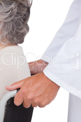 Doctor pushing patient in wheelchair