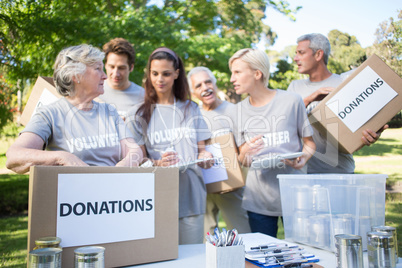 Happy volunteer family holding donation boxes