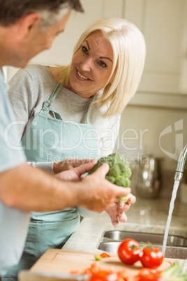 Mature couple preparing vegetables together