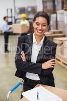 Female manager with arms crossed in warehouse