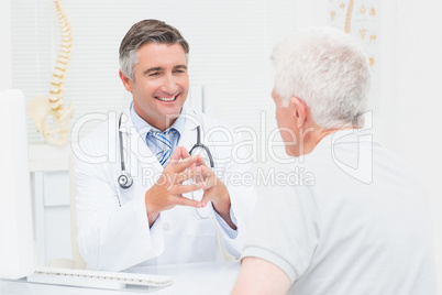 Orthopedic doctor discussing with senior patient