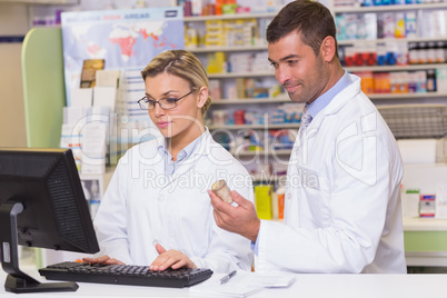 Team of pharmacists looking at the computer