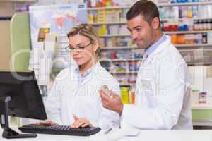 Team of pharmacists looking at the computer