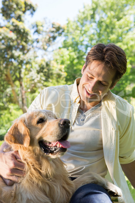 Happy man with his pet dog in park