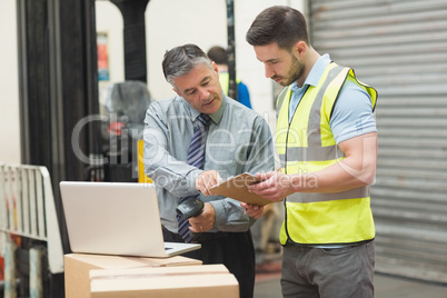 Workers scanning package in warehouse