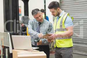 Workers scanning package in warehouse