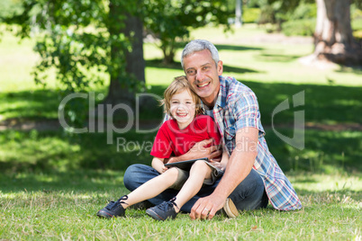 Happy father using tablet pc with his son Happy father using tablet pc with his son