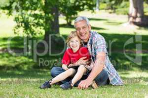 Happy father using tablet pc with his son