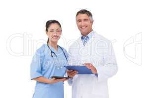 Doctor and nurse smiling at camera