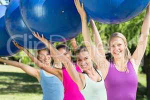 Fitness group holding exercise balls