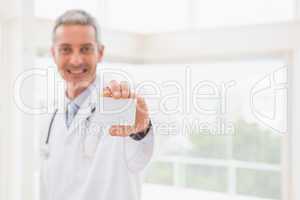 Smiling doctor showing a blank