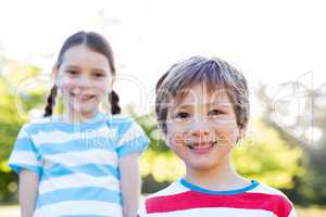 Happy siblings smiling at camera