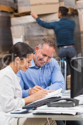 Warehouse team working together with clipboard