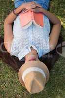 Brunette napping in the park with book