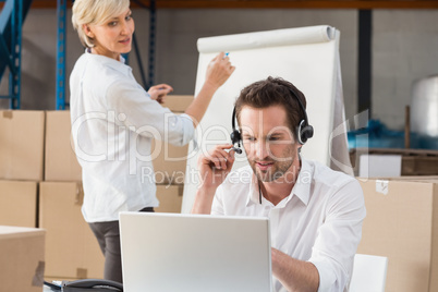 Warehouse manager using laptop during a presentation