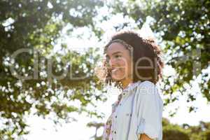 Pretty hipster smiling in the park