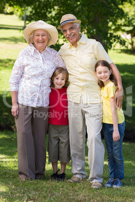 Happy grandparents with their grandchildren at the garden