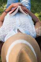 Woman napping in the park with book