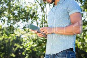 Young man using tablet in the park