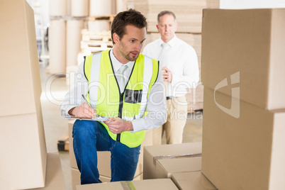 Delivery driver checking his list on clipboard