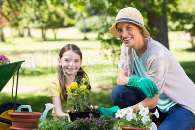 Happy blonde and her daughter gardening