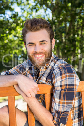 Handsome hipster relaxing in the park