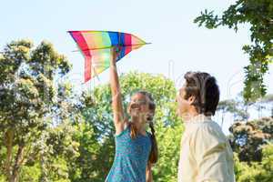 Father and daughter playing with kite