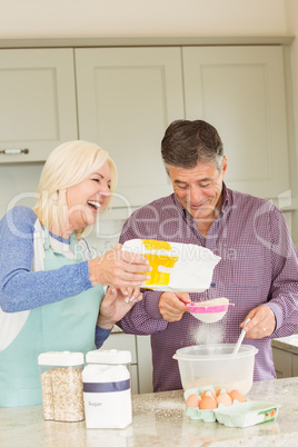 Happy mature couple baking together