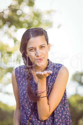 Pretty hipster blowing a kiss