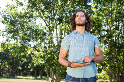 Young man using tablet in the park