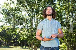 Young man using tablet in the park