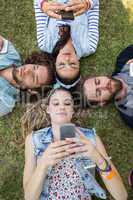 Happy friends lying on the grass