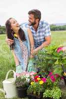 Happy young couple gardening together