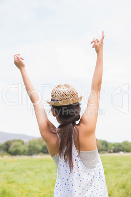 Pretty brunette feeling free in the park