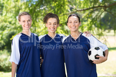 Pretty football players smiling at camera