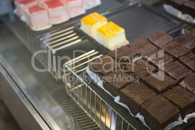 Close up of brownies and slices of cheesecake