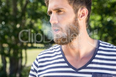 Hipster smoking electronic cigarette