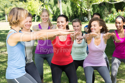 Fitness group warming up in park