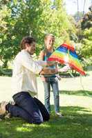 Father and daughter playing with kite