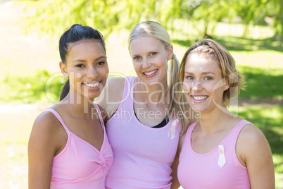 Smiling women in pink for breast cancer awareness