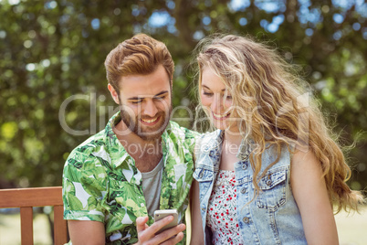 Young couple relaxing on park bench