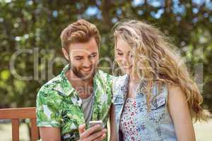 Young couple relaxing on park bench